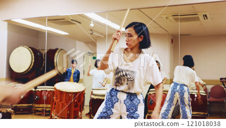Japanese drums, teacher or people in studio, music and rehearsal for festival. Group, instruments and women in class, stage creativity or hobby with song, Taiko or playing with beat, talent or rhythm 121018038
