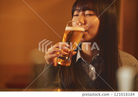 A woman drinking beer with relish. Photo courtesy of Osado Tamura. 121018184