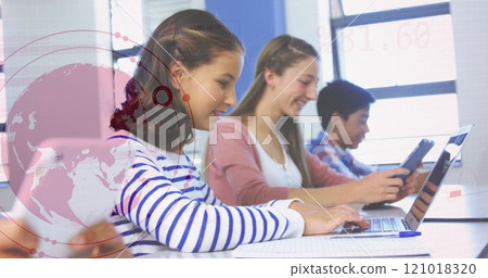 Students using laptops in classroom with data analysis image over them 121018320