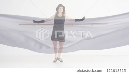 Image of caucasian woman dancing over floating cloth on white background 121018515