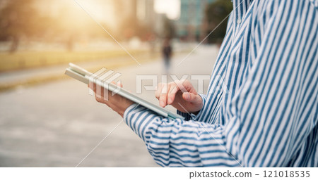 Tablet, business person and hands outdoors for networking, email and digital blueprint. Civil engineer, worker and man with internet, web research or proposal for Japan project planning review Tablet, business person and hands outdoors for networking, email and digital blueprint. Civil engineer, worker and man with internet, web research or proposal for Japan project planning review 121018535