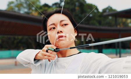Woman, archery and aim at field with sport for shooting practice and training as athlete in Japan. Tournament, female person and setup recurve bow or equipment for challenge, game and competition 121019053