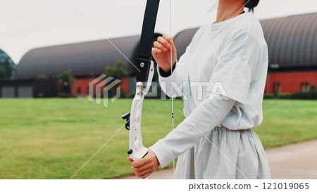 Archery, sport and hands with bow on field for shooting practice, martial arts tradition or getting ready. Japanese culture, person and equipment safety for kyudo, precision lesson or target training Archery, sport and hands with bow on field for shooting practice, martial arts tradition or getting ready. Japanese culture, person and equipment safety for kyudo, precision lesson or target training 121019065