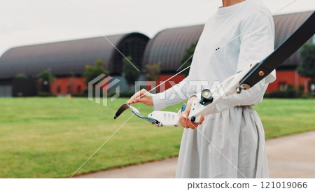 Archery, sport and hands with bow outdoor for shooting practice, martial arts tradition or getting ready. Japanese culture, person and equipment safety for kyudo, precision lesson and start training Archery, sport and hands with bow outdoor for shooting practice, martial arts tradition or getting ready. Japanese culture, person and equipment safety for kyudo, precision lesson and start training 121019066