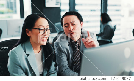 Office, manager and Asian business people on computer with feedback, review and meeting for online project. Help, corporate and worker with boss for teamwork, collaboration and discussion in Japan 121019087