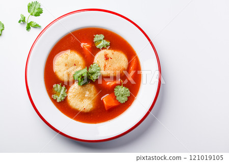 Traditional Jewish tomato soup with matza balls, white background. 121019105