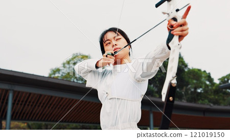 Serious, training and woman with bow, aim and preparing for competition, equipment or outdoor for game. Contest, athlete and practice from tournament, skills and challenge for person, archer or Japan Serious, training and woman with bow, aim and preparing for competition, equipment or outdoor for game. Contest, athlete and practice from tournament, skills and challenge for person, archer or Japan 121019150