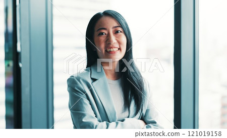 Happy, crossed arms and portrait of businesswoman in office with confidence for finance career. Smile, pride and Japanese financial manager with positive attitude for company revenue in workplace. 121019158