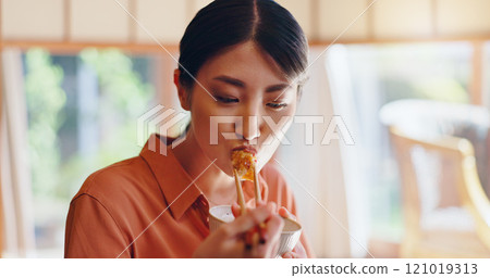 Asian woman, eating and food with chopsticks for healthy meal, snack or delicious sauce at home. Japan, female person or bite with bowl or utensils for dining tradition, culture or heritage at house Asian woman, eating and food with chopsticks for healthy meal, snack or delicious sauce at home. Japan, female person or bite with bowl or utensils for dining tradition, culture or heritage at house 121019313