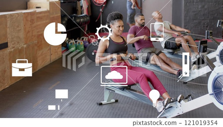 Image of business icons over diverse people using indoor rower on gym Image of business icons over diverse people using indoor rower on gym 121019354