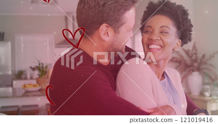 Image of hearts and light spots over diverse couple embracing in kitchen Image of hearts and light spots over diverse couple embracing in kitchen 121019416