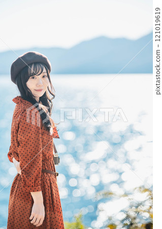 Women's trip: Woman looking at the lake 121019619