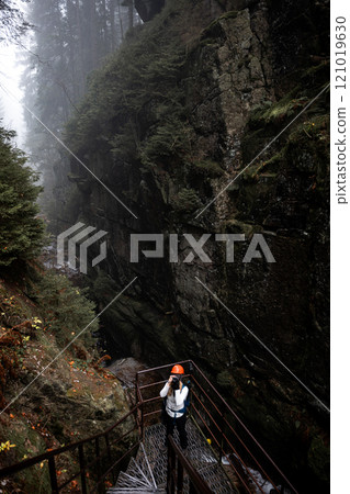 Mysterious Forest Canyon with Hiker in a Foggy and Enchanting Landscape to Explore Mysterious Forest Canyon with Hiker in a Foggy and Enchanting Landscape to Explore 121019630