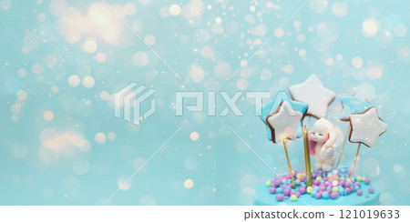 Delight fills the air as a beautifully decorated cake features whimsical cookies and vibrant sprinkles. Sparkling blue with sequins. A banner for your text. 121019633