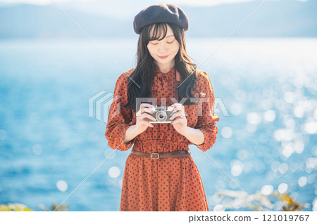 Girls' trip: Blue lake and a girl in a red dress taking pictures Girls' trip: Blue lake and a girl in a red dress taking pictures 121019767