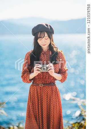 Girls' trip: Blue lake and a girl in a red dress taking pictures Girls' trip: Blue lake and a girl in a red dress taking pictures 121019768