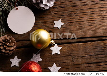 Christmas decorations with white tag and copy space on wooden background Christmas decorations with white tag and copy space on wooden background 121019797