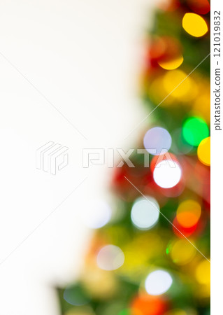 Vertical image of out of focus christmas tree with fairy lights with copy space on white background Vertical image of out of focus christmas tree with fairy lights with copy space on white background 121019832