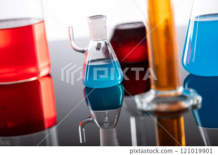 Close up of laboratory dishes with liquids and copy space on grey background 121019901