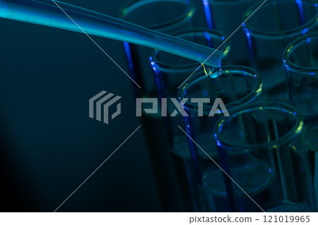 Close up of laboratory test tubes and pipette with copy space on blue background Close up of laboratory test tubes and pipette with copy space on blue background 121019965