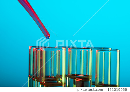 Close up of laboratory test tubes and pipette with copy space on blue background 121019966