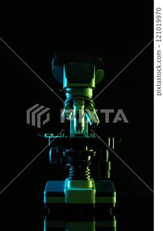 Vertical image of laboratory microscope and copy space on black background 121019970