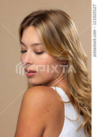 Caucasian woman wearing natural makeup on beige background 121020127