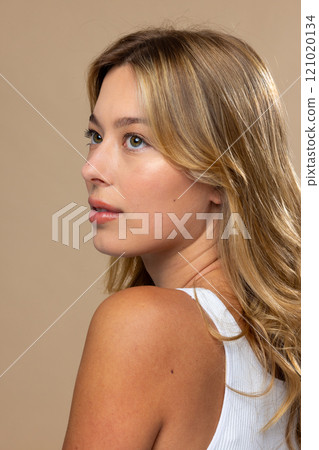 Caucasian woman wearing natural makeup on beige background 121020134