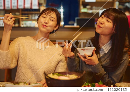 A woman eating rice with a delicious expression. Photo courtesy of Osado Tamura. 121020185