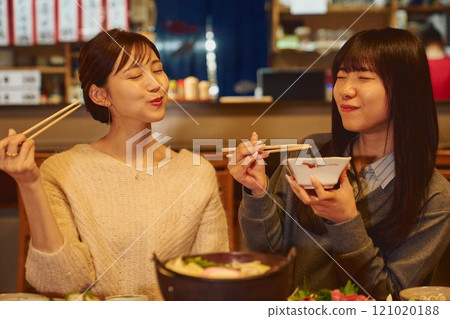 A woman eating rice with a delicious expression. Photo courtesy of Osado Tamura. 121020188