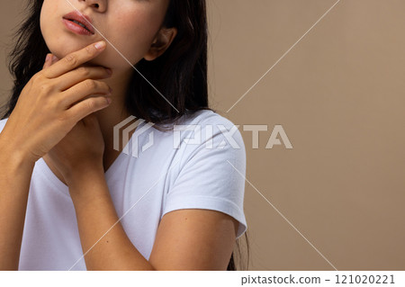 Asian woman wearing natural makeup and white t-shirt on beige background, copy space 121020221