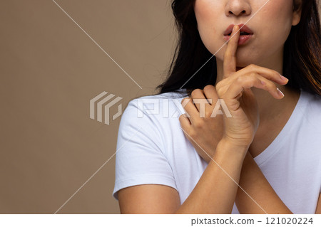 Asian woman wearing natural makeup and white t-shirt on beige background, copy space 121020224