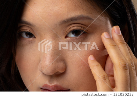 Portrait of asian woman wearing natural makeup on beige background 121020232