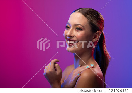 Caucasian woman wearing red lipstick and blue nail polish on purple background, copy space 121020383