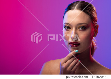 Portrait of caucasian woman wearing blue nail polish on purple background, copy space Portrait of caucasian woman wearing blue nail polish on purple background, copy space 121020389