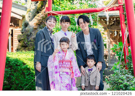 A family celebrating Shichi-Go-San with their siblings at a shrine A family celebrating Shichi-Go-San with their siblings at a shrine 121020426