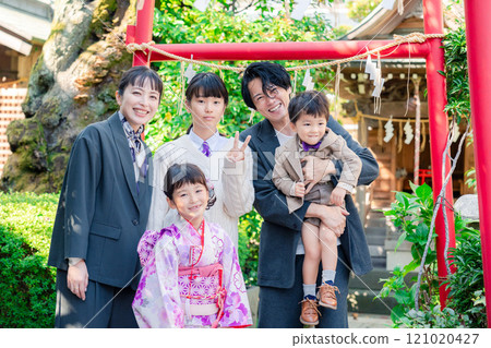 A family celebrating Shichi-Go-San with their siblings at a shrine A family celebrating Shichi-Go-San with their siblings at a shrine 121020427