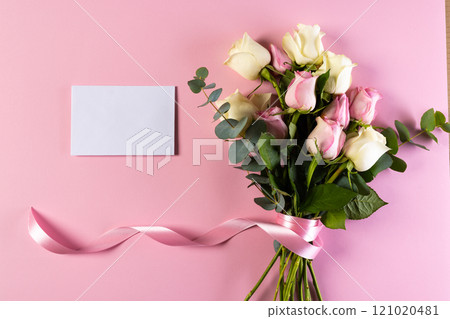 Pink and white rose flowers and white card with copy space on pink background Pink and white rose flowers and white card with copy space on pink background 121020481