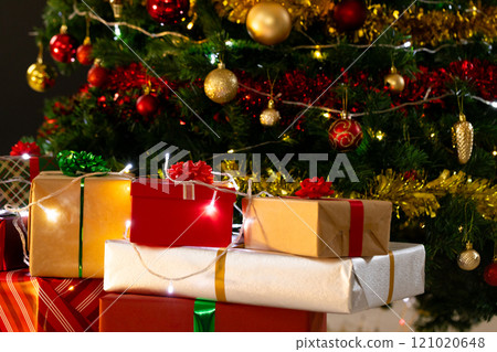 Presents and christmas tree with baubles, decorations and copy space Presents and christmas tree with baubles, decorations and copy space 121020648