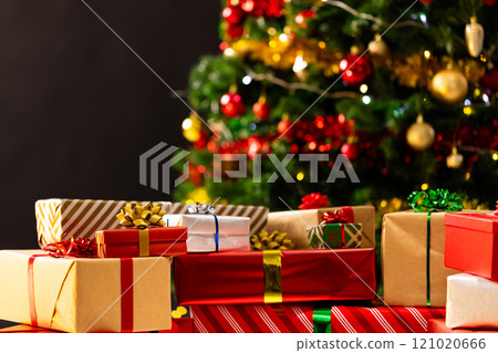 Presents and christmas tree with baubles and decorations with copy space Presents and christmas tree with baubles and decorations with copy space 121020666
