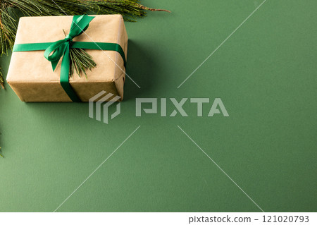 Christmas presents with green ribbon and copy space on green background Christmas presents with green ribbon and copy space on green background 121020793