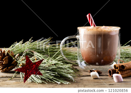 Glass mug of chocolate and marshmallows and christmas decorations with copy space 121020856