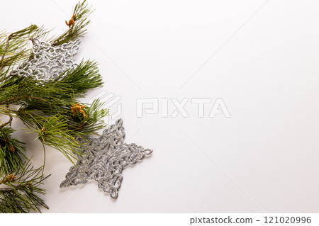 Christmas tree and star baubles decorations with copy space on white background Christmas tree and star baubles decorations with copy space on white background 121020996