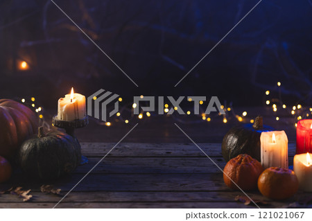 Pumpkins and dry leaves with copy space on dark background Pumpkins and dry leaves with copy space on dark background 121021067