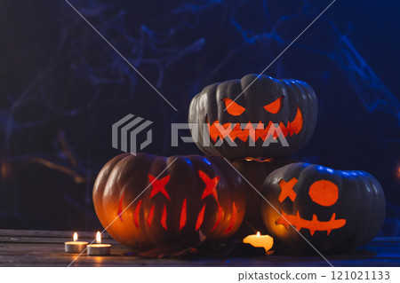 Carved pumpkins and candls with copy space on dark background Carved pumpkins and candls with copy space on dark background 121021133