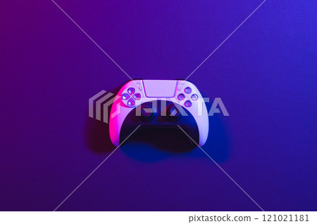 Composite of video game pad and copy space on neon background Composite of video game pad and copy space on neon background 121021181