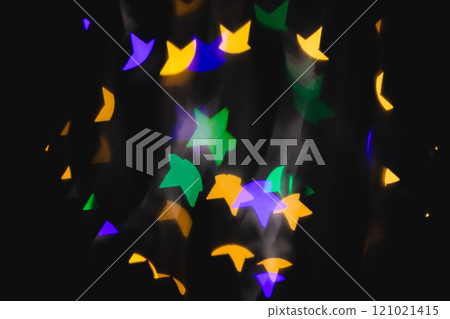 Multicoloured star bokeh lights with copy space on dark background 121021415