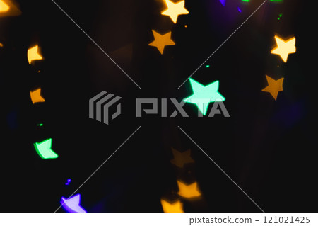 Multicoloured star bokeh lights with copy space on dark background Multicoloured star bokeh lights with copy space on dark background 121021425
