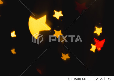 Multicoloured star bokeh lights with copy space on dark background Multicoloured star bokeh lights with copy space on dark background 121021430