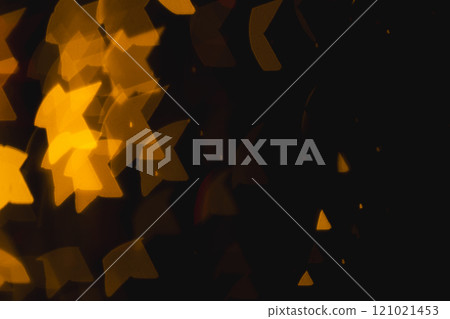Yellow star bokeh lights with copy space on dark background Yellow star bokeh lights with copy space on dark background 121021453